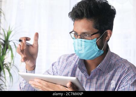Businessman In a video conference discussing strategy on digital tablet  Stock Photo