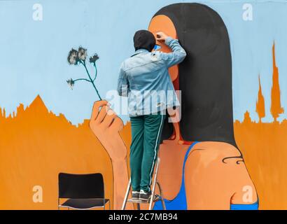 Glasgow, Scotland, UK. 18th July, 2020. An artist at work on a new mural for The Clutha Bar. A group of artists have been chosen by street art group Art Pistol to provide new murals to the exterior face of the famous Glasgow bar. Credit: Skully/Alamy Live News Stock Photo