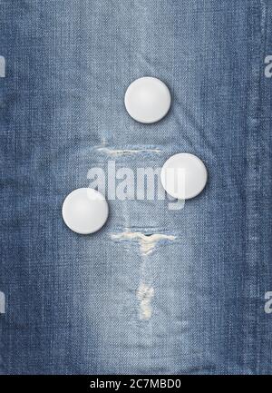 Three blank badges on a blue denim background Stock Photo
