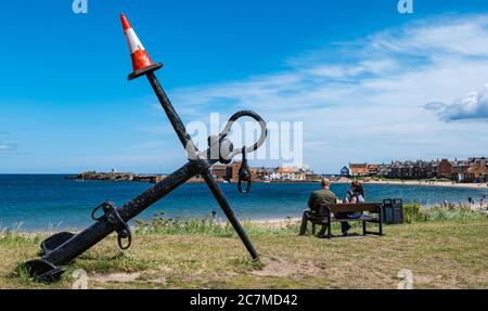 North Berwick, East Lothian, Scotland, United Kingdom, 18th July 2020. UK Weather: Summer sunshine in a very busy seaside town which is back to normal albeit with social distancing measures in place. The iconic anchor on West beach has acquired a traffic cone