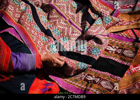 Womans hand holding colorful woven fabrics, Chaullacocha vilage, Andes Mountains, Peru, South America Stock Photo