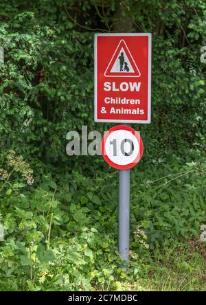Slow children and animals red road sign with a 10 speed limit Stock Photo