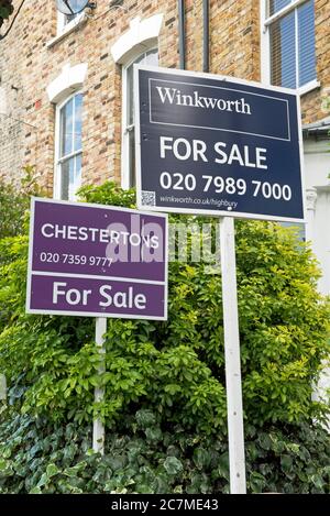 Two estate agents boards outside house in Holloway, London Borough of Islington, N7 Stock Photo