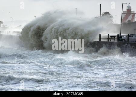 Huge storm waves smashing into the seawall in Cape Town during an intense winter storm. Stock Photo