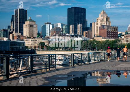 View of the Montreal skyline with runners jogging in the foreground in Montreal, Canada - province of Quebec. Stock Photo