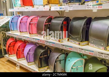 Tokyo / Japan - September 15, 2018:  Typical Japanese school backpacks lined up on store shelves. The backpacks are made of sturdy leather and come in Stock Photo