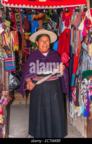 Ecuadorian woman in native costume at equator museum near Quito. Stock Photo