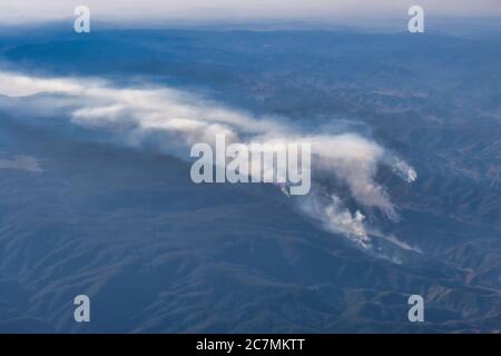 Aerial view of several bush fires together in the bush country in central east New South Wales, Australia, with smoke pouring into the sky Stock Photo