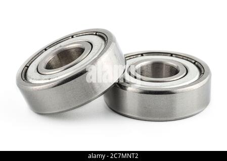 Macro shot of two ball bearings, isolated on a white background, selective focus. Stock Photo