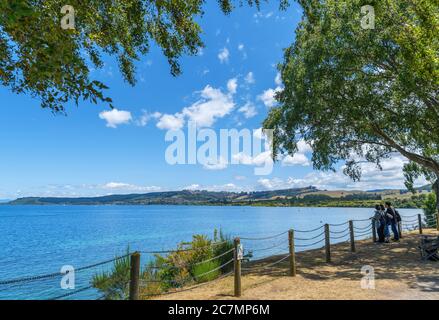 Tourists on the lakefront in Taupo, Lake Taupo, New Zealand Stock Photo