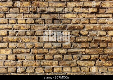 Wall made out of brown rectangular stones Stock Photo