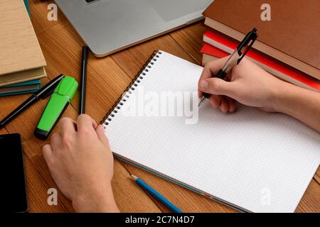 Worker writing in a notepad, making notes or summary Stock Photo