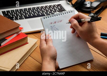 Man writing a to do list in a notepad Stock Photo