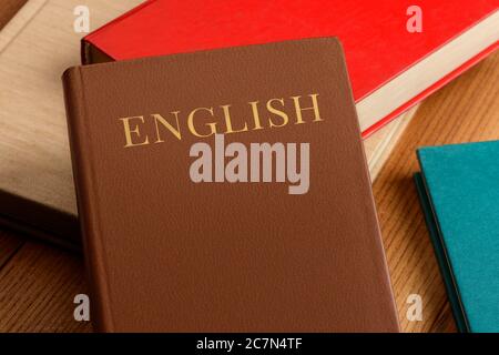 Pile of books on table. Learning English with grammar book Stock Photo