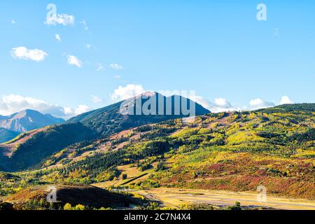 High angle aerial view of Aspen city, Colorado USA buttermilk ski slope hill in rocky mountains peak with colorful autumn foliage aspen trees in Roari Stock Photo