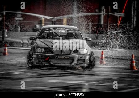 Milan, Italy, June 02, 2018:black BMW racing car in action on wet asphalt during the 1st Drift Show Il Destriero at the Iper Drive in Milan. Stock Photo