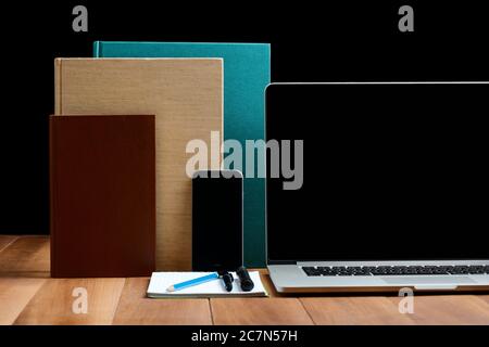 Phone, notebook and books on wooden table Stock Photo
