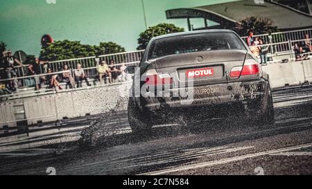 Milan, Italy, June 02, 2018:black BMW racing car in action on wet asphalt during the 1st Drift Show Il Destriero at the Iper Drive in Milan. Stock Photo