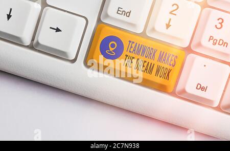 Writing note showing Teamwork Makes The Dream Work. Business concept for to work together toward a common vision Colored keyboard key with accessories Stock Photo