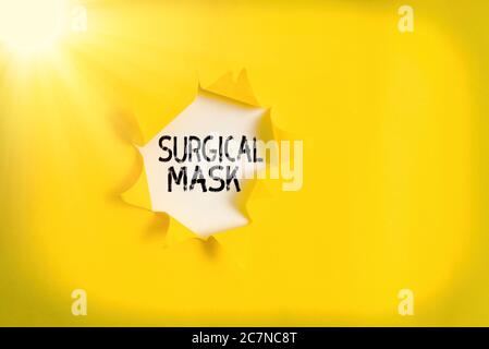 Handwriting text Surgical Mask. Conceptual photo worn by health professionals during surgery and during nursing Rolled ripped torn cardboard placed ab Stock Photo