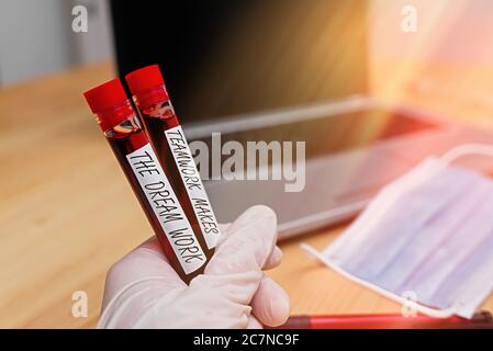 Writing note showing Teamwork Makes The Dream Work. Business concept for to work together toward a common vision Blood sample vial lastest technology Stock Photo
