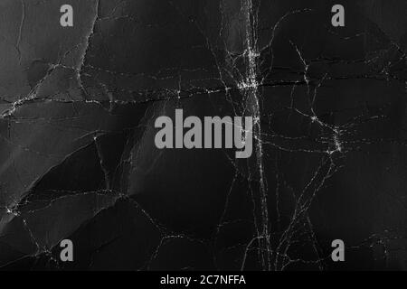 Worn black cardboard with wrinkles and scuffs. Paper dark abstract background for design. Packaging material. The concept of Halloween and horror movi Stock Photo