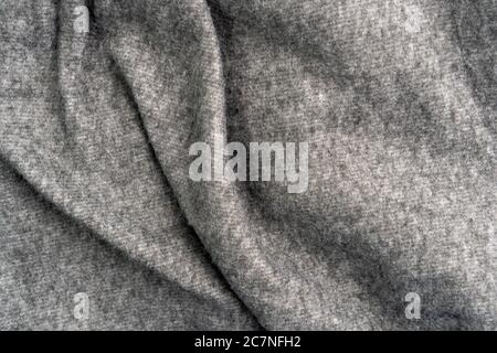 Crumpled gray woolen fabric with folds and wrinkles. Close-up Stock Photo