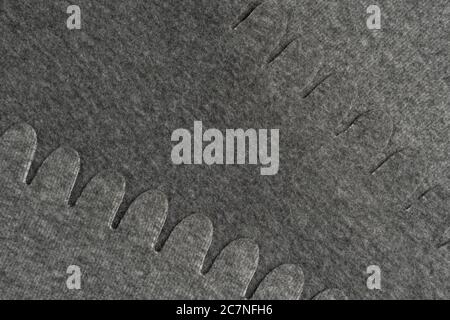 Gray wool material with patterned edges. Close-up. Abstract background. Stock Photo