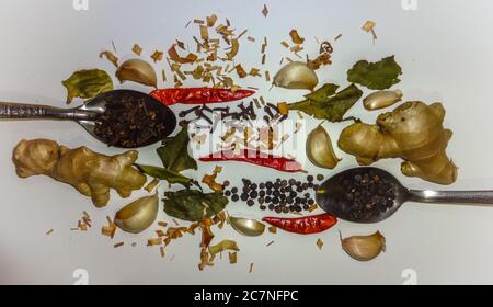 Different types of herbs and spices for cooking on a white table Stock Photo