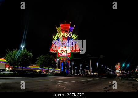 Wendover, USA - July 27, 2019: Nevada city near Utah border with Burger special at Rainbow hotel and Casino on road at night illuminated neon lights Stock Photo