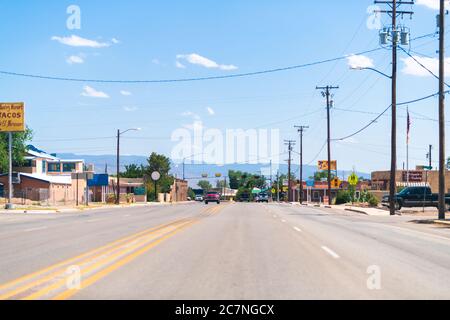 Tularosa, USA - June 8, 2019: New Mexico countryside small city town street road with stores shops buildings and mountains in background Stock Photo