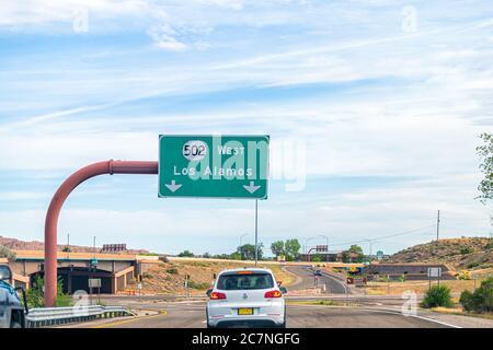 Santa Fe, USA - June 17, 2019: New Mexico desert with cars on road highway sign to Los Alamos driving with street 502 west Stock Photo