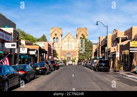 Santa Fe, USA - June 14, 2019: Old town street road in United States New Mexico city with adobe style architecture and famous church with shops stores Stock Photo