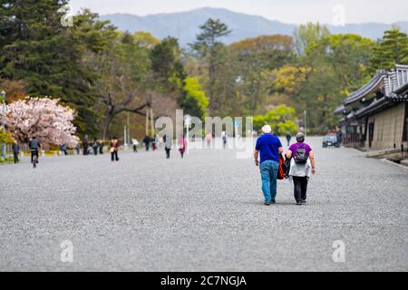 Kyoto, Japan - April 17, 2019: City street in Kyoto gyoen Imperial Palace entrance with people tourists foreigners walking on grounds in spring with c Stock Photo