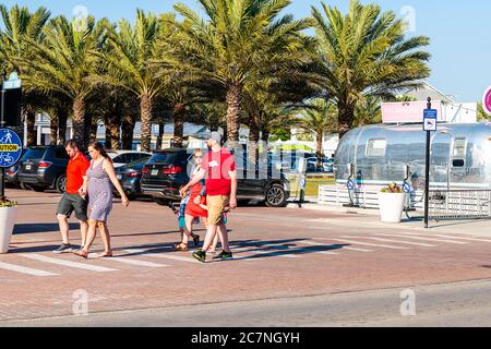 Seaside, USA - April 25, 2018: Retro vintage restaurant cafe sign for Five Daughters Bakery in city town beach village and people crossing road street Stock Photo