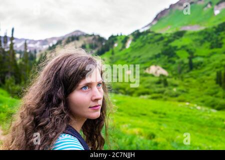 Albion Basin, Utah summer with woman face portrait closeup and landscape view on meadows trail to Cecret lake in Wasatch mountains Stock Photo