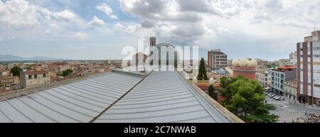 Panorama with St. Peter Church behind glass dome of Dali Theatre and Museum from roof of Ernest Lluch Health Centre in Figueres, Catalonia, Spain. Stock Photo