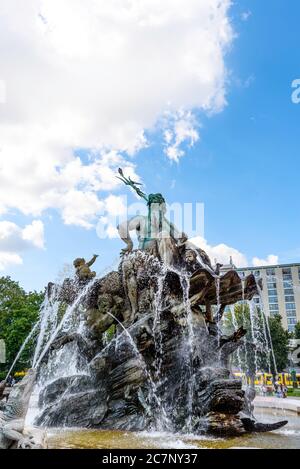 The Neptune fountain in Berlin on the background of blue sky in Berlin Germany September Stock Photo