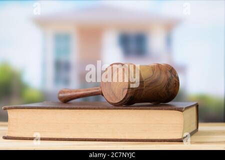 Gavel, law books with building in background. Construction law concept. Stock Photo