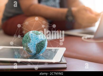 Mock up the globe with digital social media network on notebook at home. Concept of Connection, Communication, Technology, Network. Stock Photo