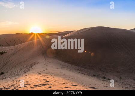 Sunset or evening view of Sand dunes in XiangshaWan, or Singing sand Bay, in hobq or kubuqi desert, Inner Mongolia, China Stock Photo