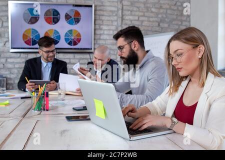 Successful business partners having a meeting and discussing new business project ideas in an office Stock Photo