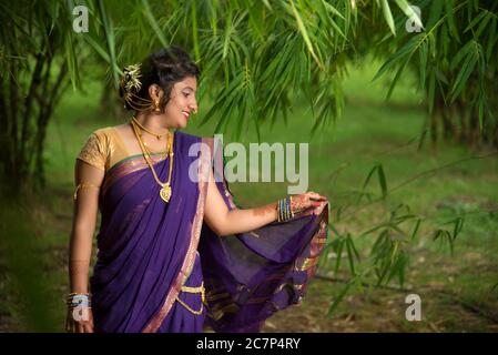 Image of Indian traditional Beautiful Woman Wearing an traditional Saree  And Posing On The Outdoor With a Smile Face-FF420028-Picxy