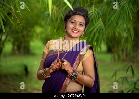 Image of Indian traditional Beautiful Woman Wearing an traditional Saree  And Posing On The Outdoor With a Smile Face-KS917948-Picxy