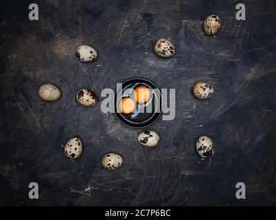 Quail eggs with yolks on wooden background. Stock Photo