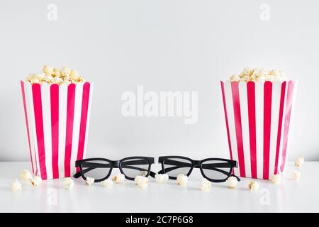 cinema and date concept - two striped boxes with popcorn, 3d glasses and copy space over white background Stock Photo