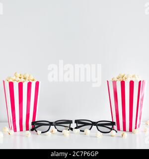 cinema concept - striped boxes with popcorn, 3d glasses and copy space over white background Stock Photo