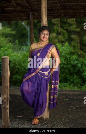 Indian woman in traditional saree looks back and smilingg Stock Photo |  Adobe Stock