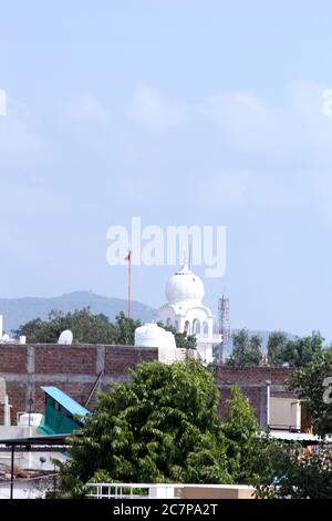 Gurudwara or temple of the Sikhs in city, Indian street background with old house and nature in Indore, India-july 2020 Stock Photo