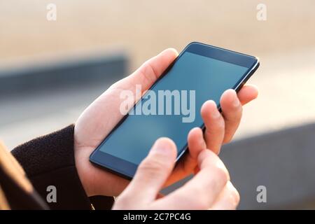 Businessman using his Mobile Phone outdoor, close up Stock Photo